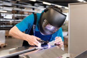 Mobile welder repairing metalwork on-site in Lewisham